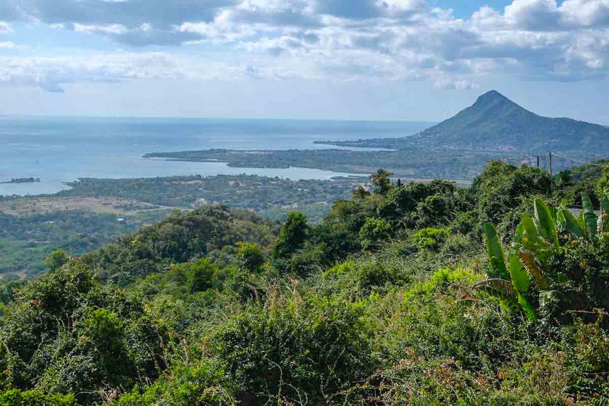 viewpoint in mauritius with a small volcanic mountain looking out ove rhe ocean