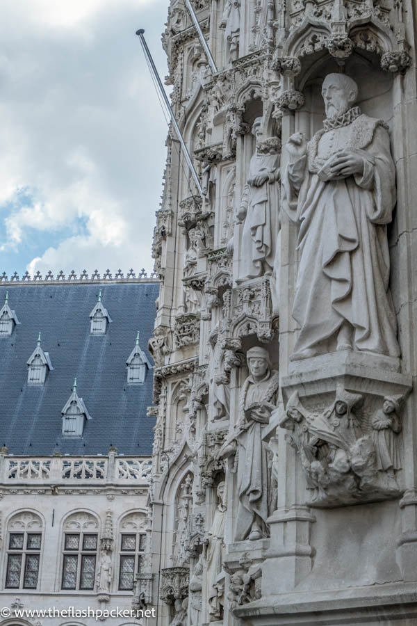 stone sculptures on the exterior of the town hall in leuven belgium