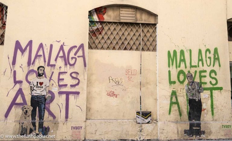 wall mural of 2 men and a dog and the writing malaga loves street art