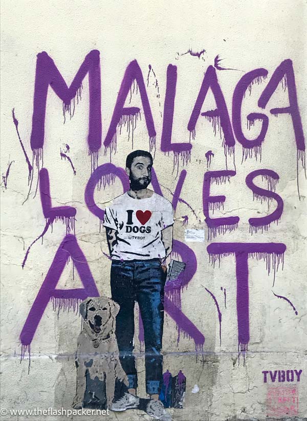 mural of a man with an i love dogs t shirt in soho which is one of the best areas to stay in Malaga Spain