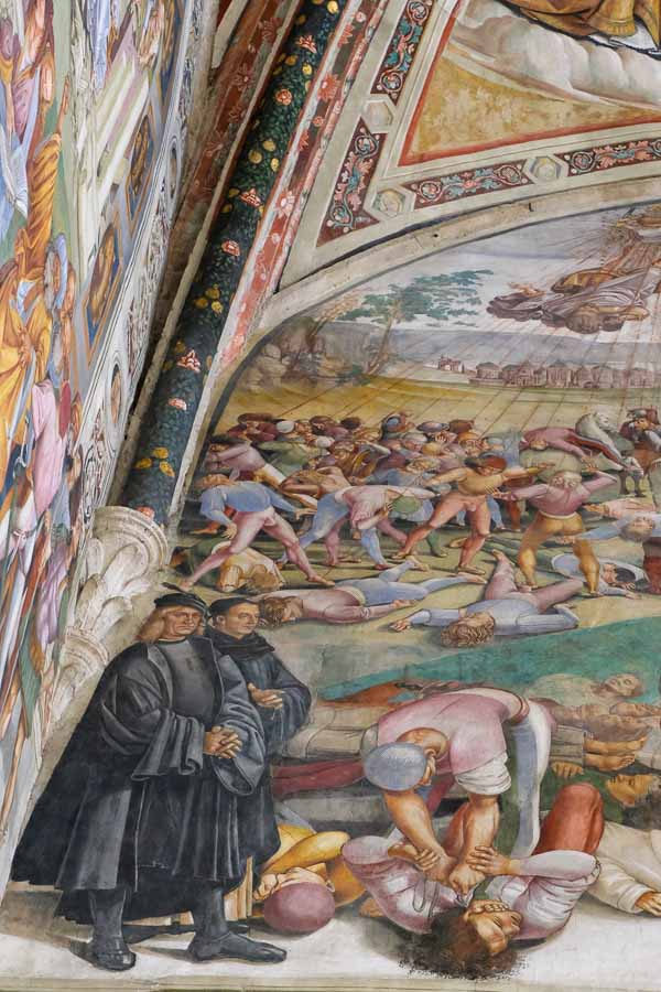 fresco in church showing two men dressed in black robes