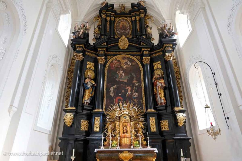 dark wood altar with paintings and gilded tabernacle