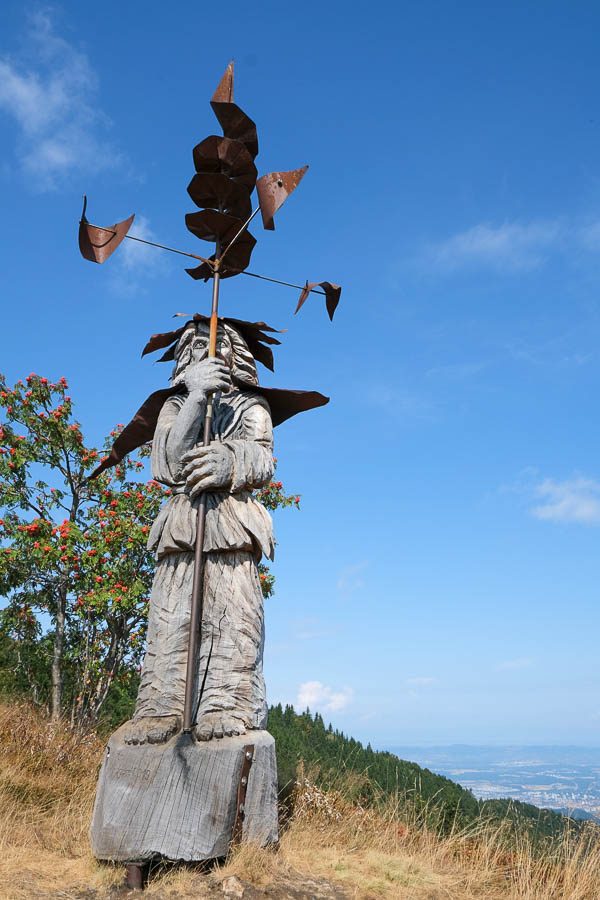 modern sculpture of a man with a wind vane