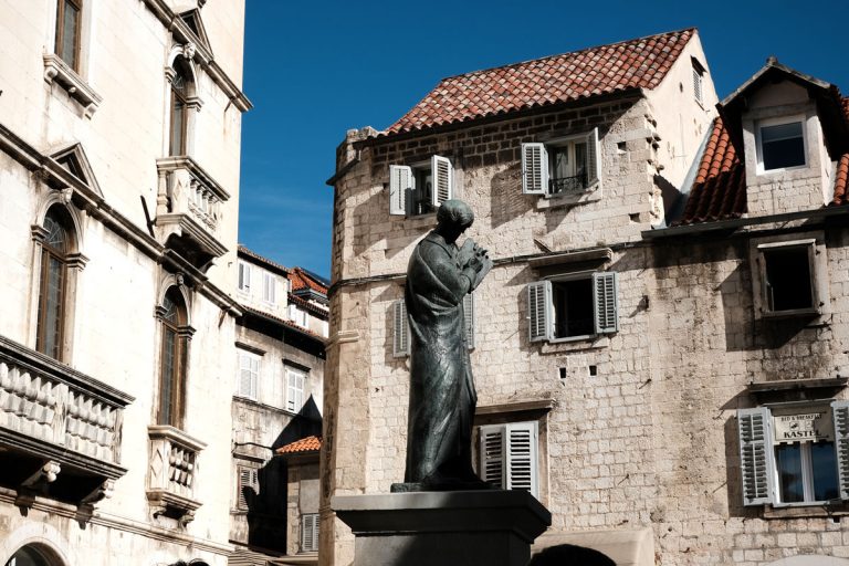 statue and houses in piazza in split old town seen when exploring diocletian's palace