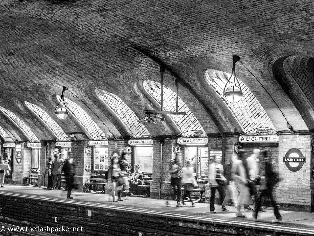 people on platform at baker street tube station in london
