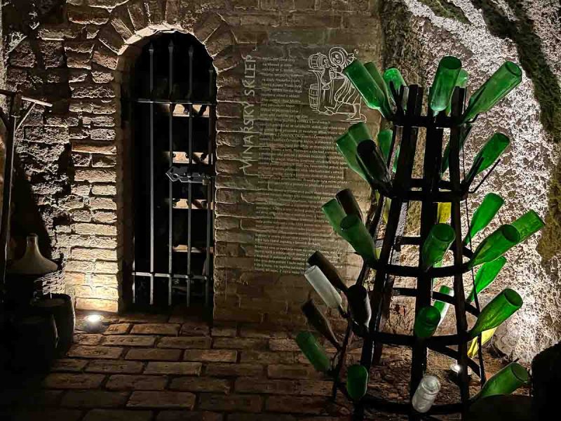 green bottles in a rack in the underground labyrinth in brno