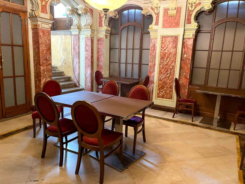 table and 5 red chairs in a room