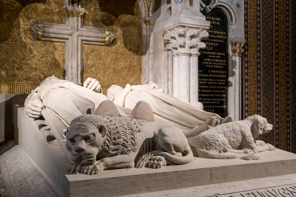 carved stone lion at the foot of a dual sarcophagus