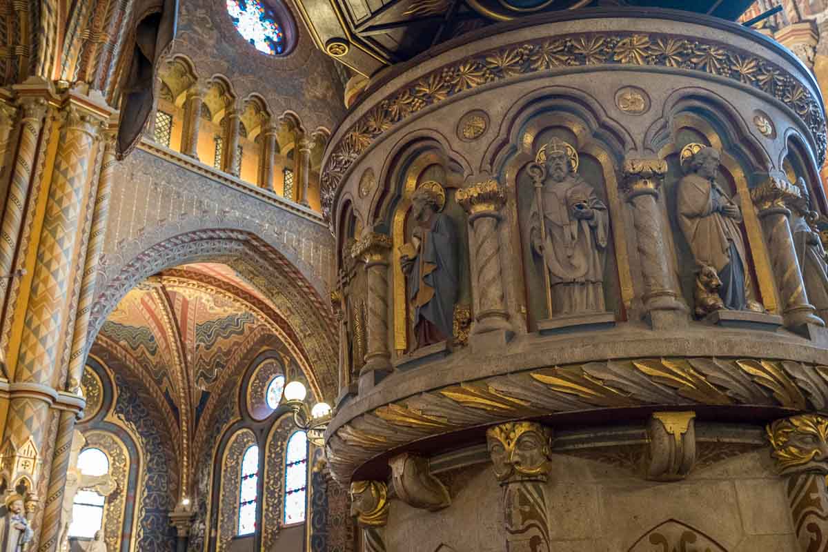 stone pulpit in matthias church in budapest with painted figures