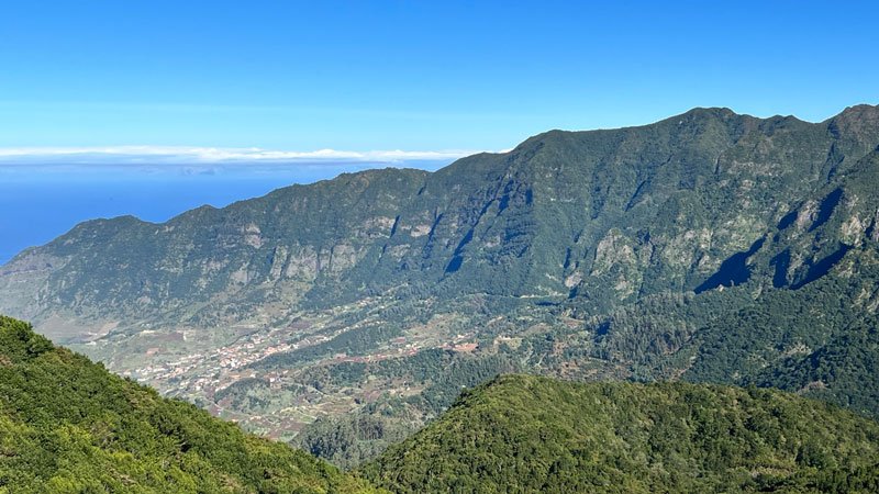 landscape in madeira with a deep valley and forested slopes