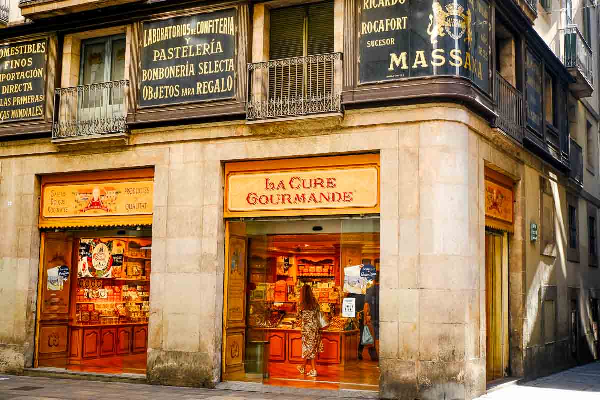 2 Days in Barcelona: A Tried & Tested Itinerary 1 woman at counter in old spanish food shop