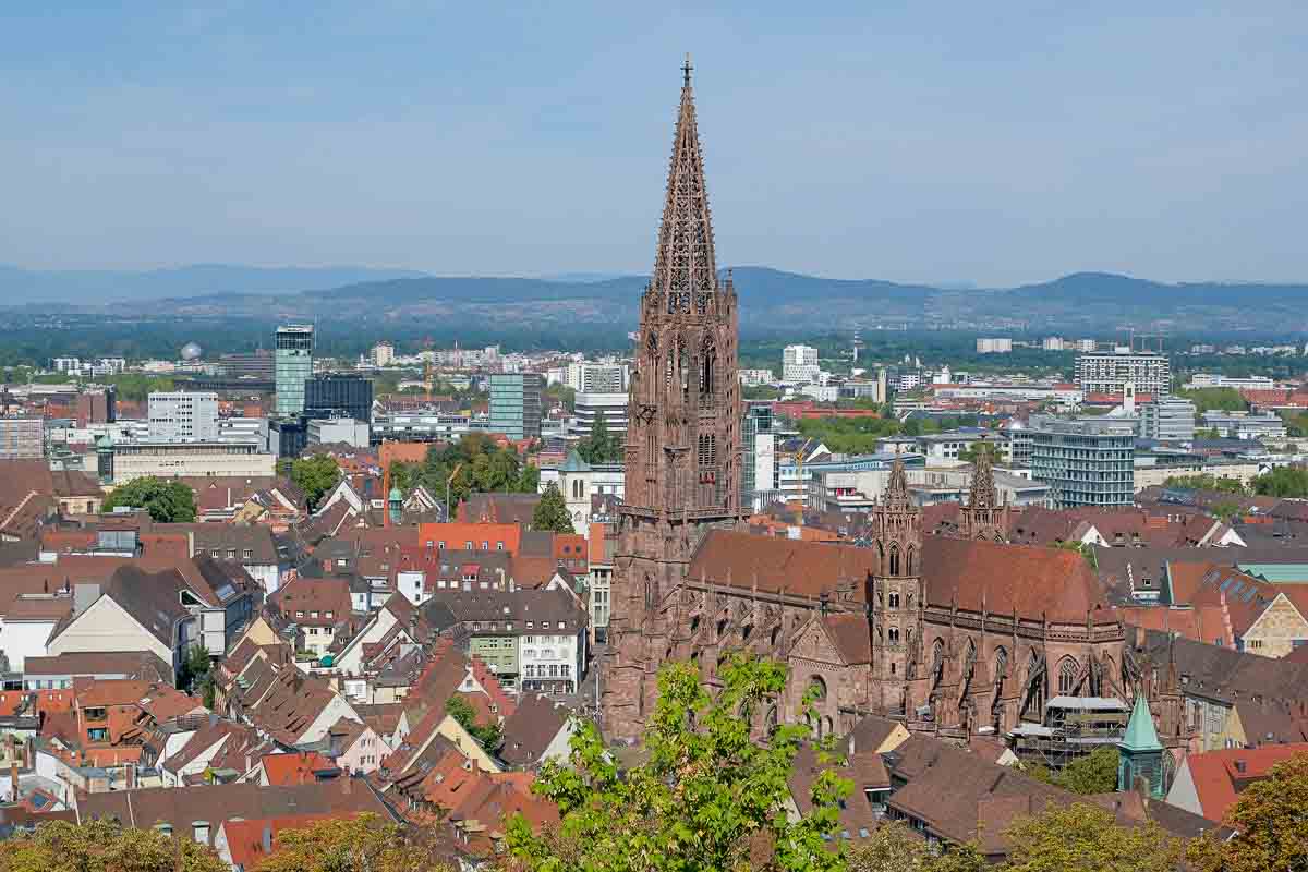 Unmissable Things to Do in Freiburg, Germany 1 panoramic view of red roofs of Freiburg germany with large sandstone gothic cathedral in centre