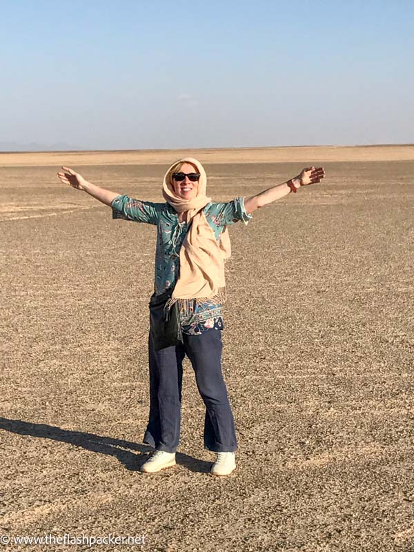 Solo Travel 1 women with arms outstretched in desert