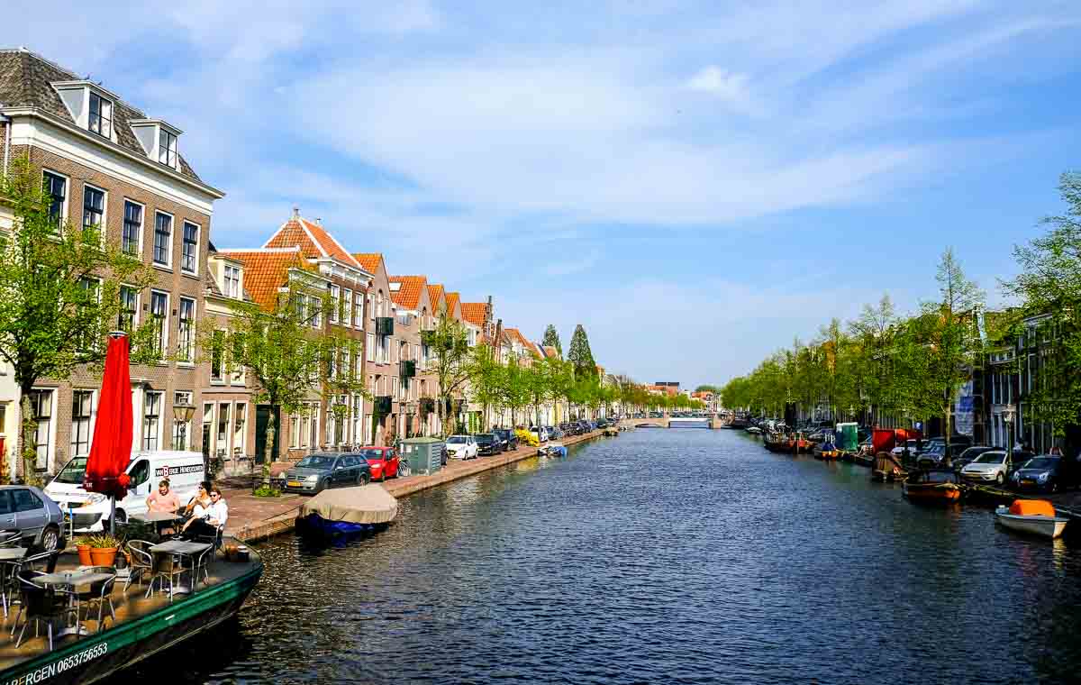 One Day in Leiden: A Self-Guided Walking Tour 1 canal with buildings on each side an a boat moored