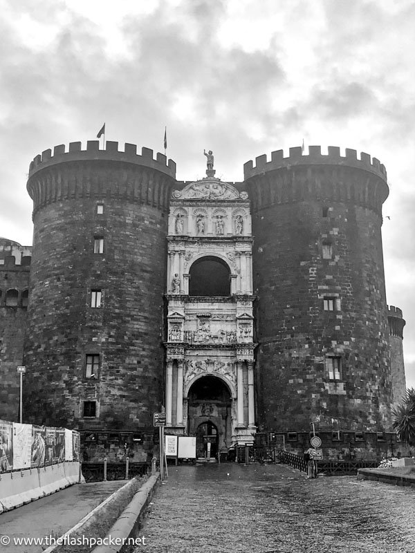 entrance to nuovo castle in naples with 2 turreted towers