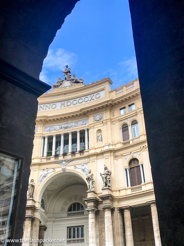 cream colored baroque building seen through an arch
