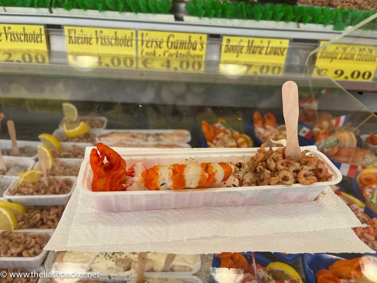 a tray of assorted seafood on the counter of a seafood shack