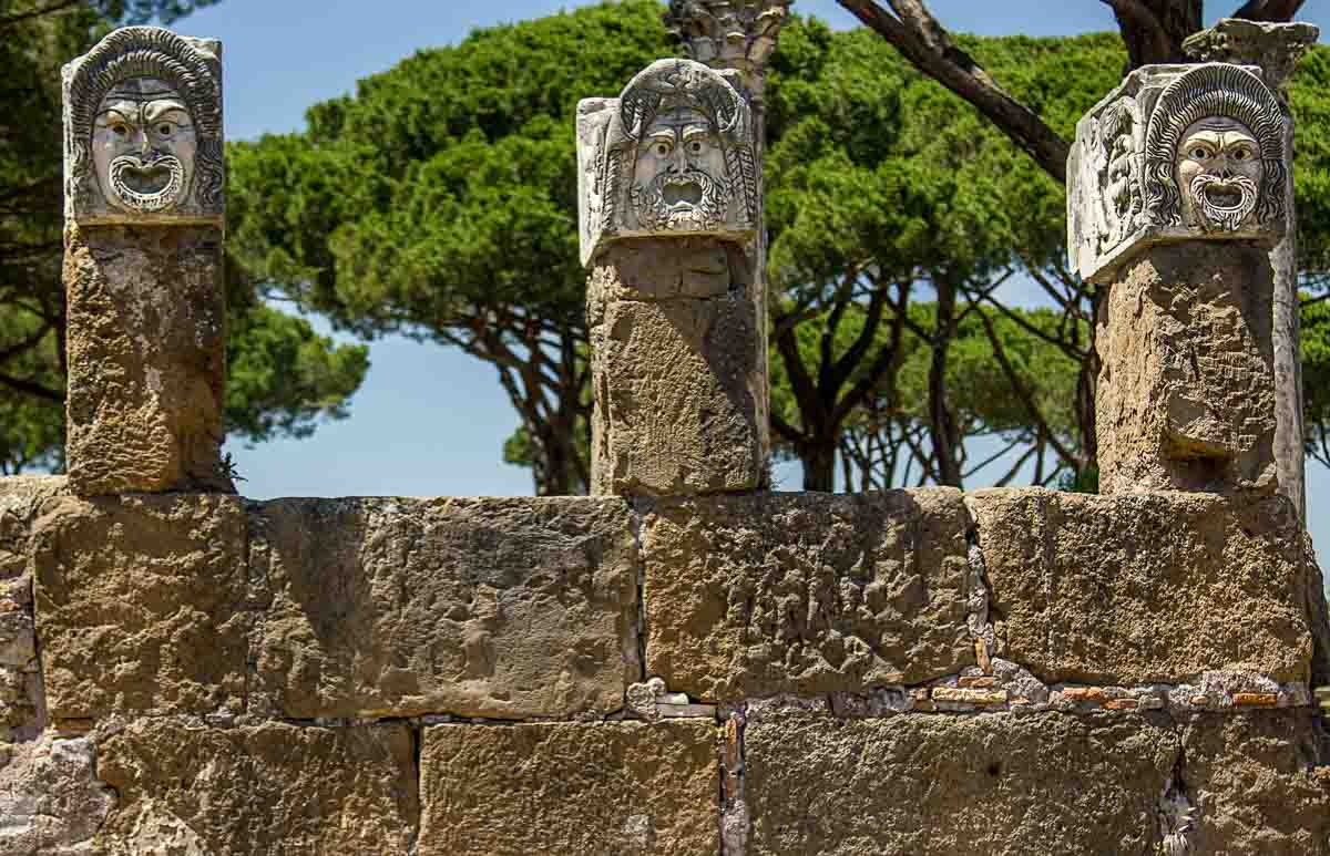 Ostia Antica or Pompeii as a Day Trip from Rome? 1 stone heads on top of columns at the ancient roman site of ostia antica visited as a day trip from rome