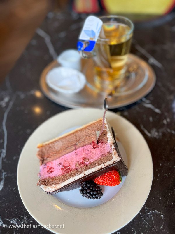 slice of strawberry and chocolate cake and cup of tea