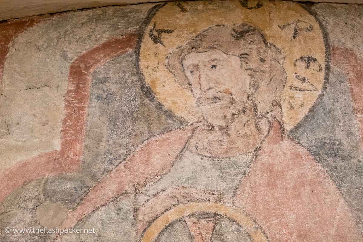 faded wall fresco of christ
