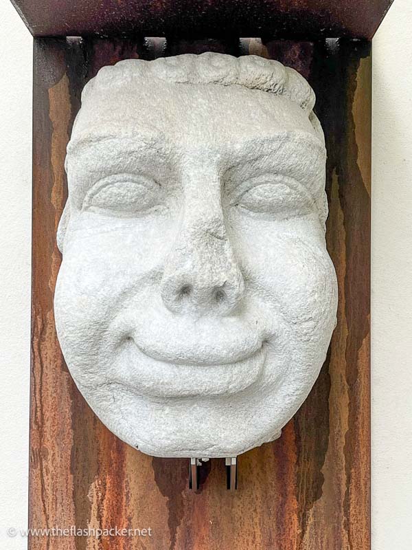 stone sculpture of a smiling man
