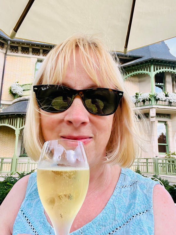 France 15 woamn in sunglasses holding a glass of champagne