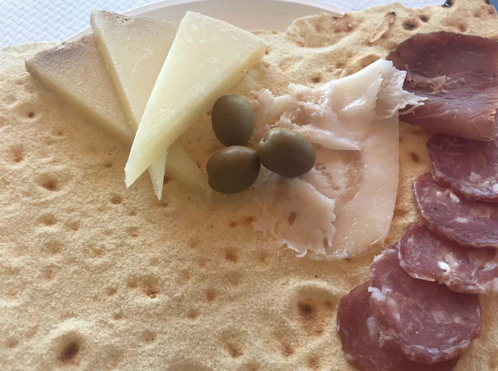 flatbread with cheese olives and cold meats