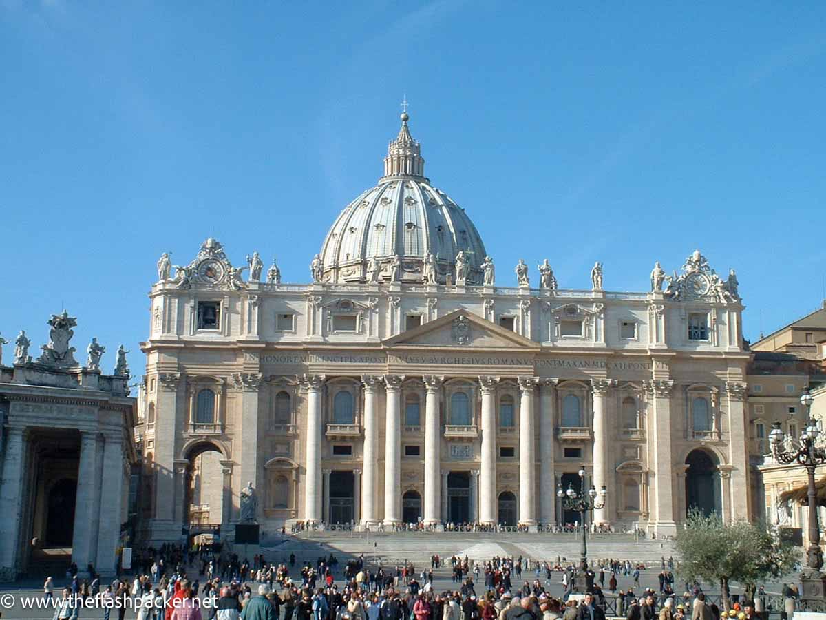 people gathered outside the facade of st peters basilica in rome
