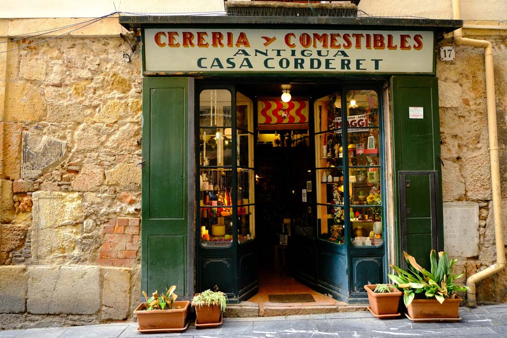 old candle shop with green shutters