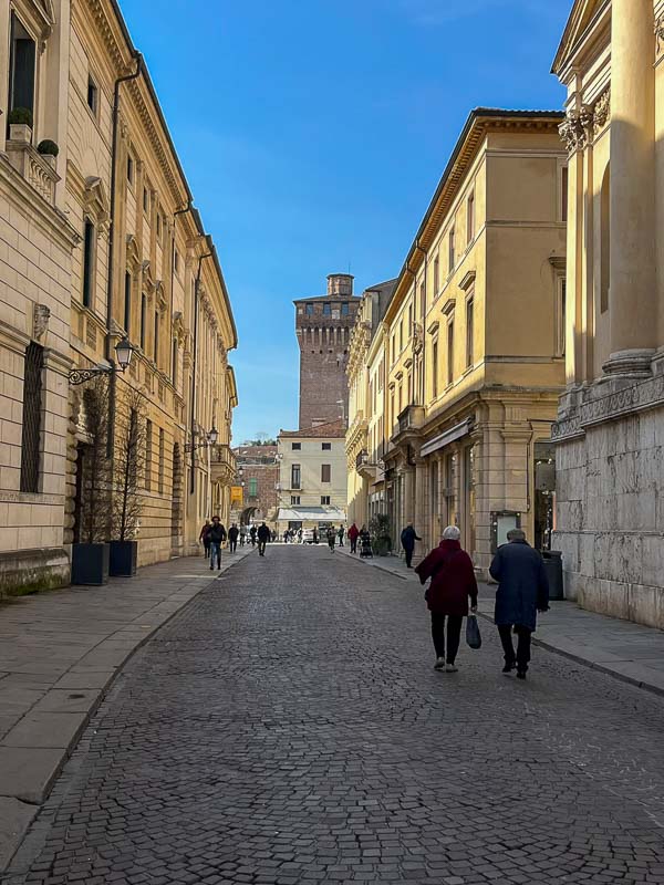 people walking in cobbled street in vicenza historic centre